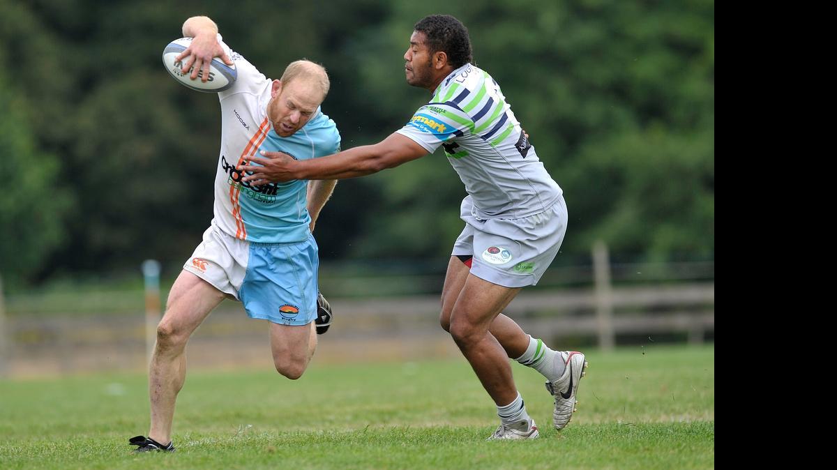 
Chuckanut's Micah Bartlett, left, evades Seattle's William Rasalika in the second half of the match at the Can-Am Sevens Rugby Tournament Saturday, July 11, at the Bellingham Polo Grounds.
