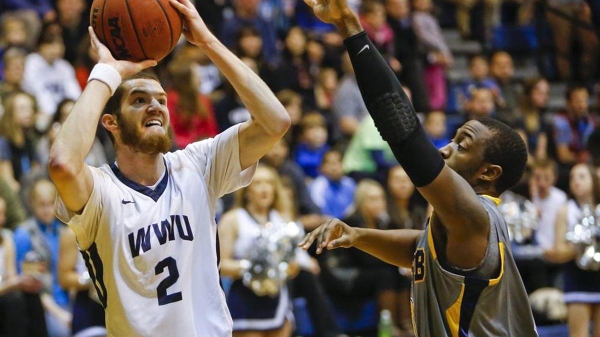 Western Washington University’s Kyle Impero, left, puts up a shot against Montana State University, Billings, in January 2015 at Sam Carver Gymnasium.