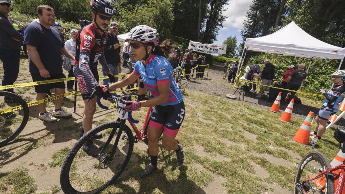 Cyclocross competitor Courtenay McFadden with the Boundary Bay Brewery Women team hops on her bike at the canoe to cyclocross transfer point during the 2016 Sea to Ski race May 29 at Hovander Park in Ferndale. McFadden has been selected to USA Cycling’s women’s elite team for the 2017 UCI World Cyclocross Championships.