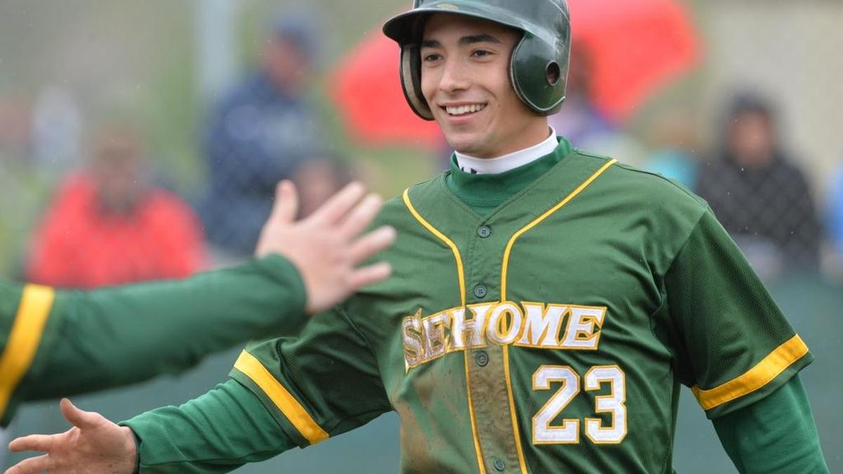 Sehome’s Josh Zavisubin gets a hand from a teammate after scoring a run against Ferndale in April 2014. Zavisubin was added as a 10-day player by the Bellingham Bells on Wednesday, May 25.