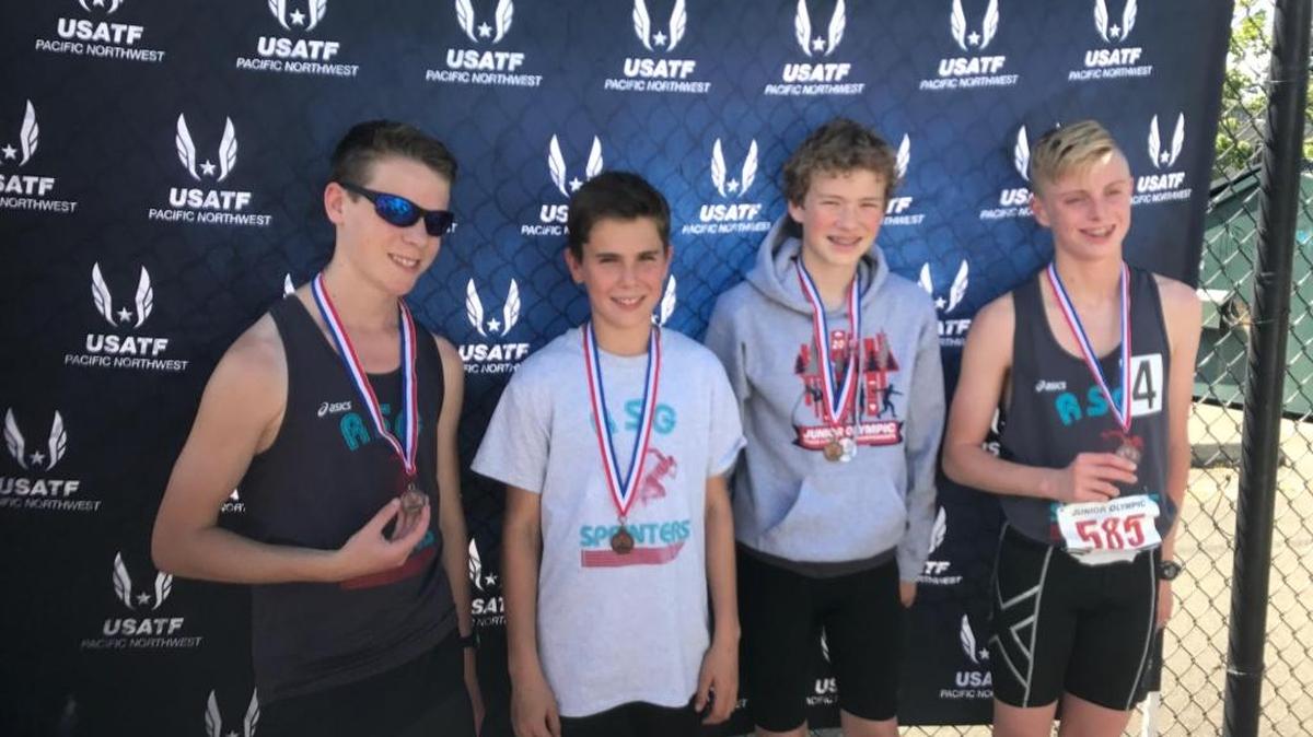 Ready-Set-Go Sprinters Cam Chase (from left), Carter Birade, Josh Bates and Landon Sturdevant celebrate finishing third in the 4x400 relay in the qualifying rounds for the regional Junior Olympics