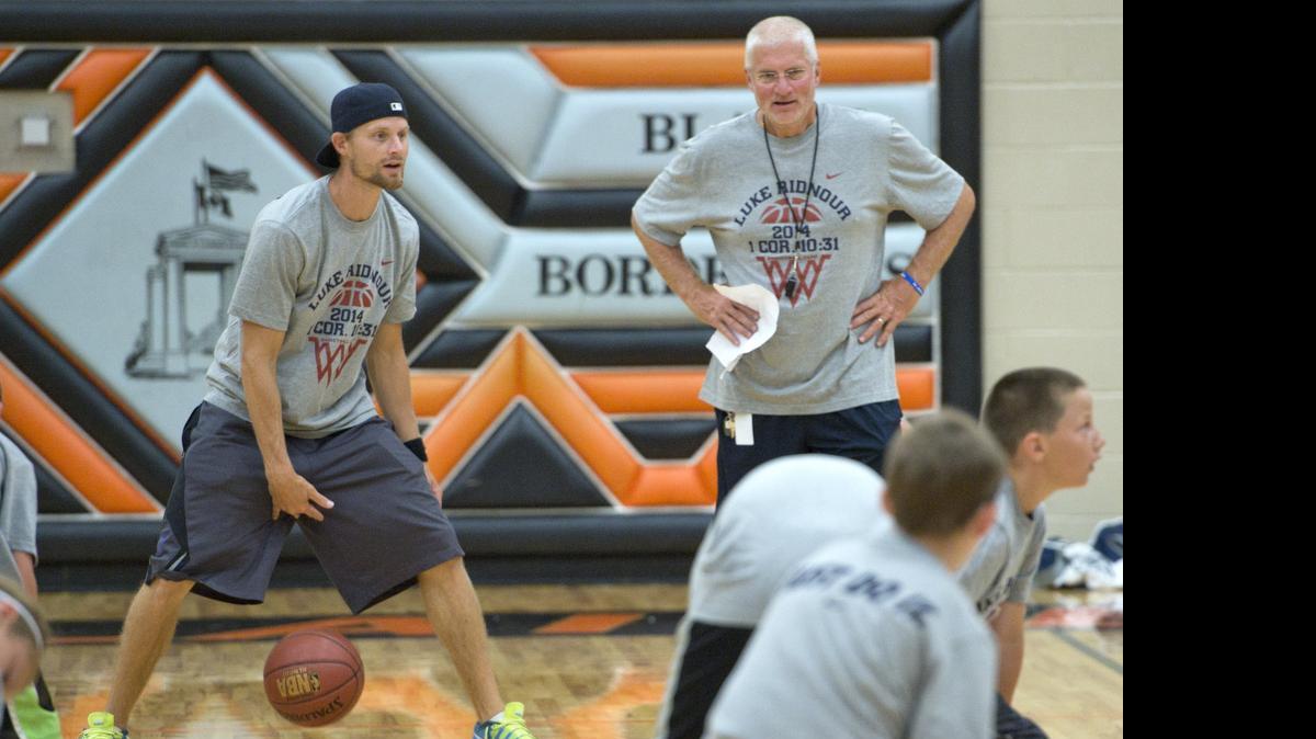 
Luke Ridnour, left, with his dad Rob Ridnour, right, work on dribbling skills with local kids as the Luke Ridnour, talks to kids about working on fundamentals and practicing at the 2014 Luke Ridnour Basketball Camp. The 2015 camp will be held July 29-31.
