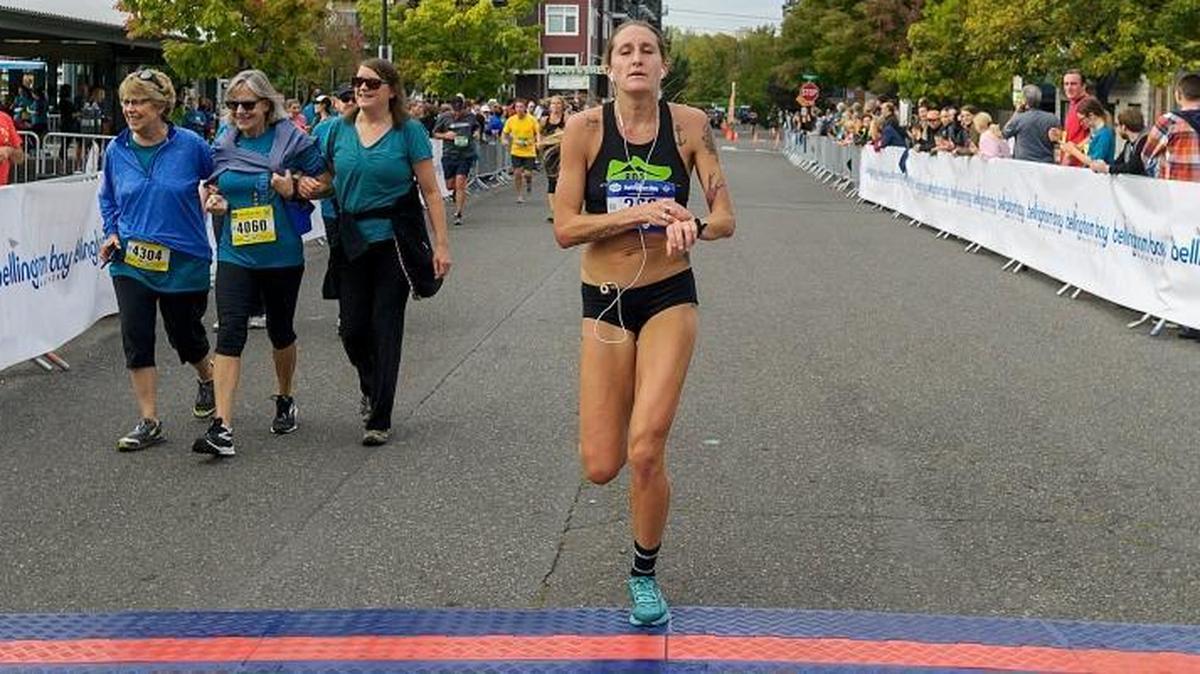 Bellingham’s Courtney Olsen crosses the finish line of the 2017 Bellingham Bay Marathon Sept. 24. Olsen earned first place in the women's division and fourth place overall with a time of 2:46:35.