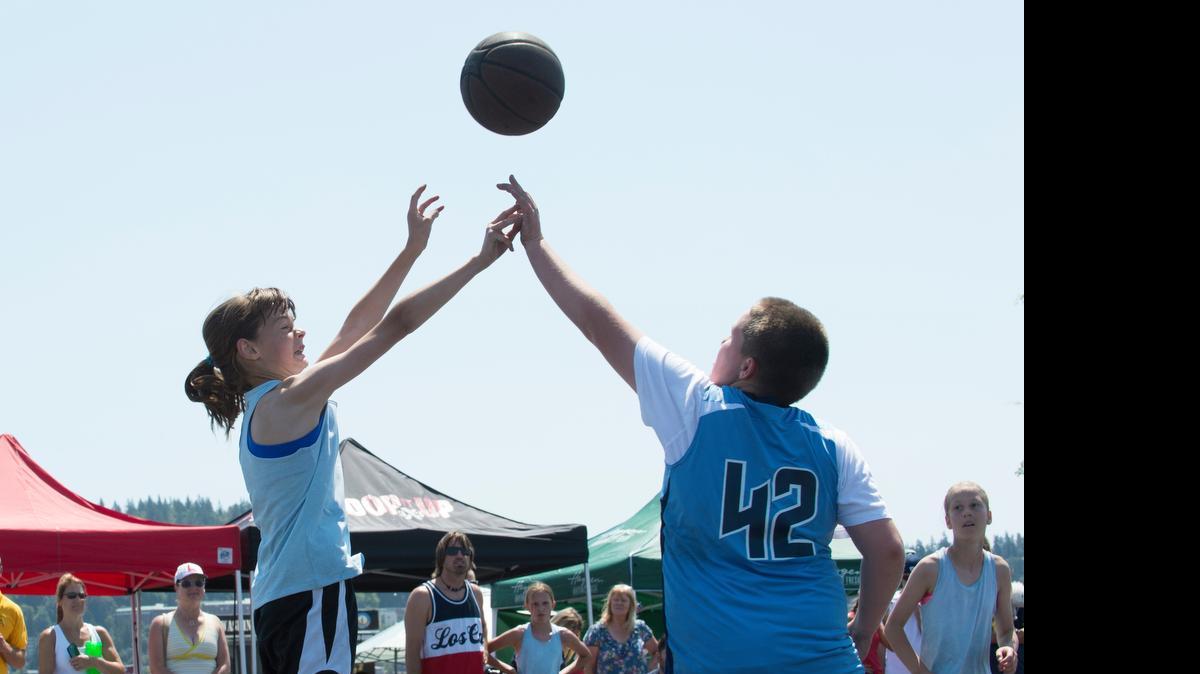 
Ava Collins of team Angels of Destruction shoots and scores at the Bellingham Hoop It Up 3-on-3 Basketball Tournament on Saturday, July 4, at Zuanich Point Park in Bellingham. 
