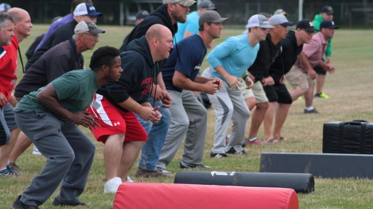 Local football coaches conduct a drill during the Heads Up Football player safety clinic, held July 16 at Meridian High School.