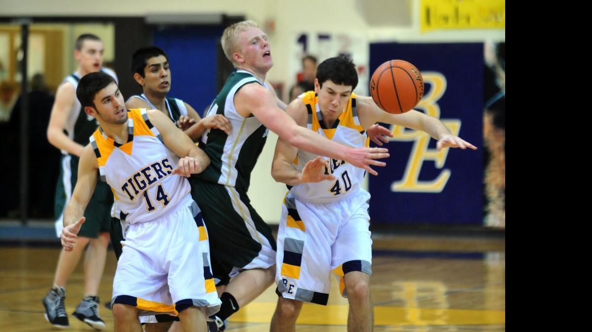 
Sehome's Tyler Miksovsky, center, reaches for a loose ball between Burlington-Edison's Evan Coulter, left, and Joel Conijn in a February 2010 game at Burlington.
