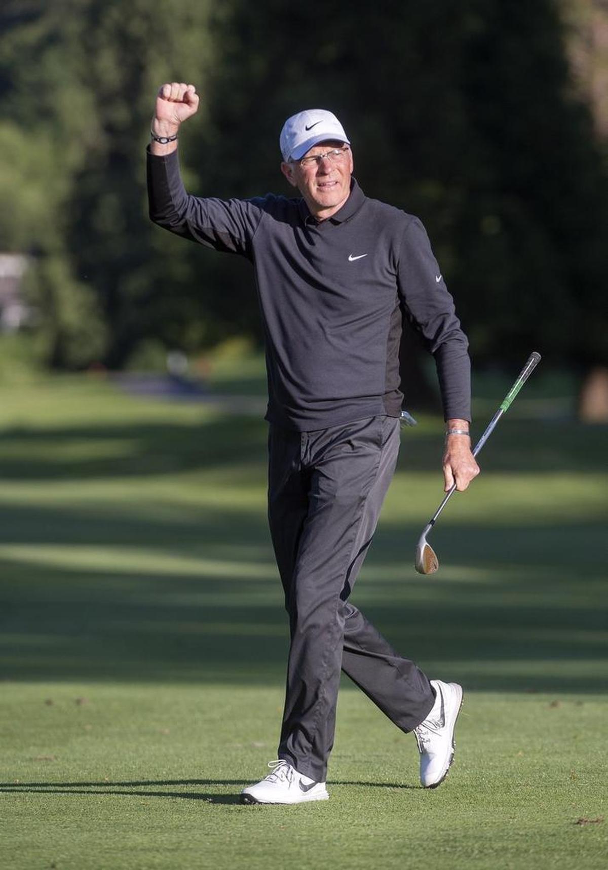 Jeff Coston pumps his fist after making a key chip onto the 18th green, leaving him a short birdie putt at the 2016 Washington Open Invitational at Meridian Valley Country Club in Kent. Now 61, Coston is the oldest player to win the tournament.