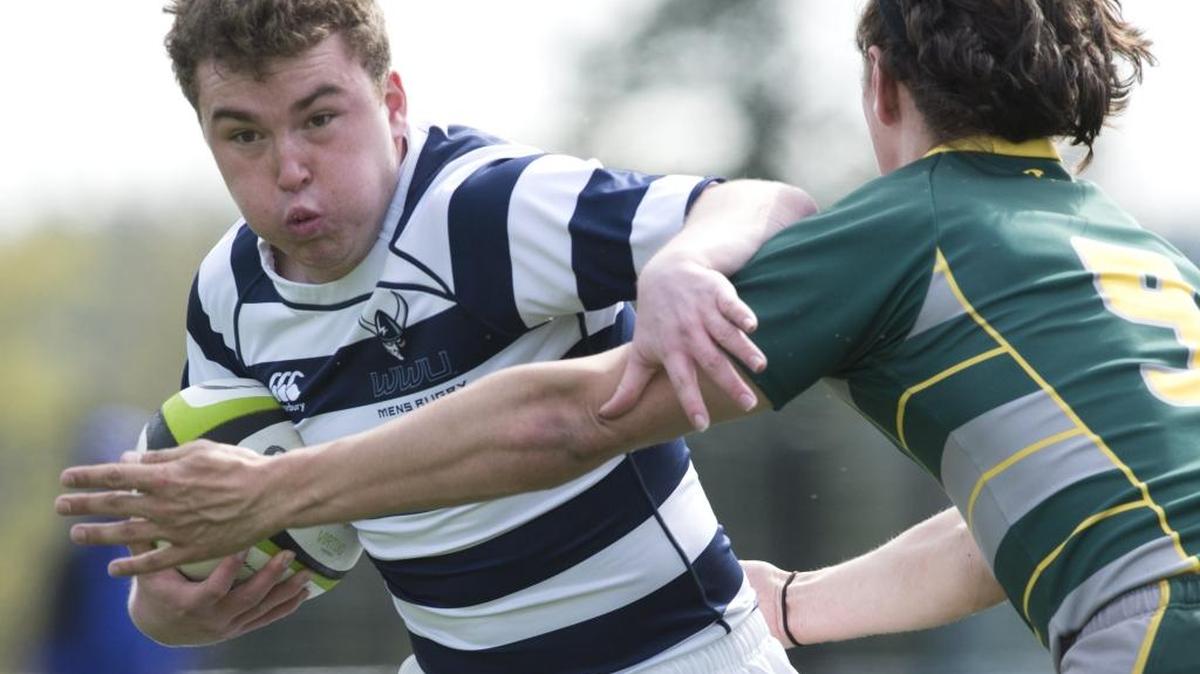 Western Washington’s Connor Augustine, left, runs through Oregon’s Charlie Tschudin on in April 2015. Western hosts the Collegiate Rugby Association of America’s Div. IAA 7s National Championships this May.