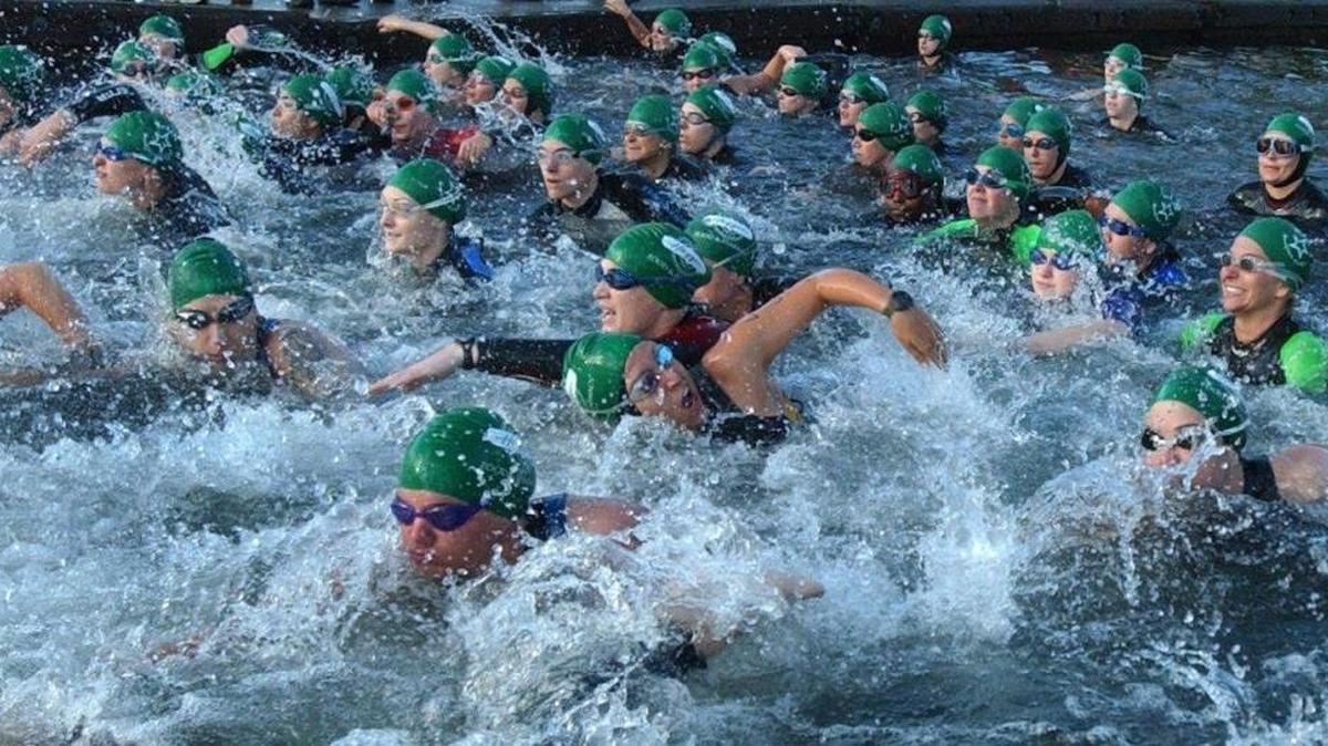 A wave of women splash into the chilly waters of Lake Whatcom at Bloedel Donovan Park for the first leg of the Baker’s Breakfast Cookie Triathlon Sunday morning in June 2004. The Lake Whatcom Triathlon returns to Bellingham in July.