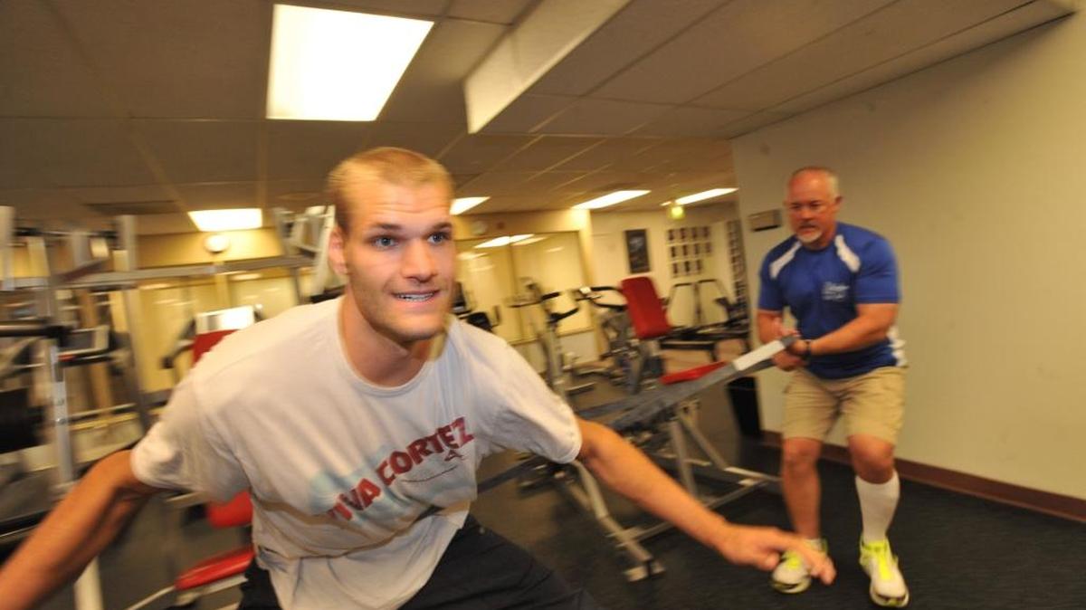 
Former Lynden Christian High basketball star Kyle Coston, left, works out under the guidance of Mike Locke on Wednesday, July 11, 2012, at the Belllingham Athletic Club on Meridian Street.
