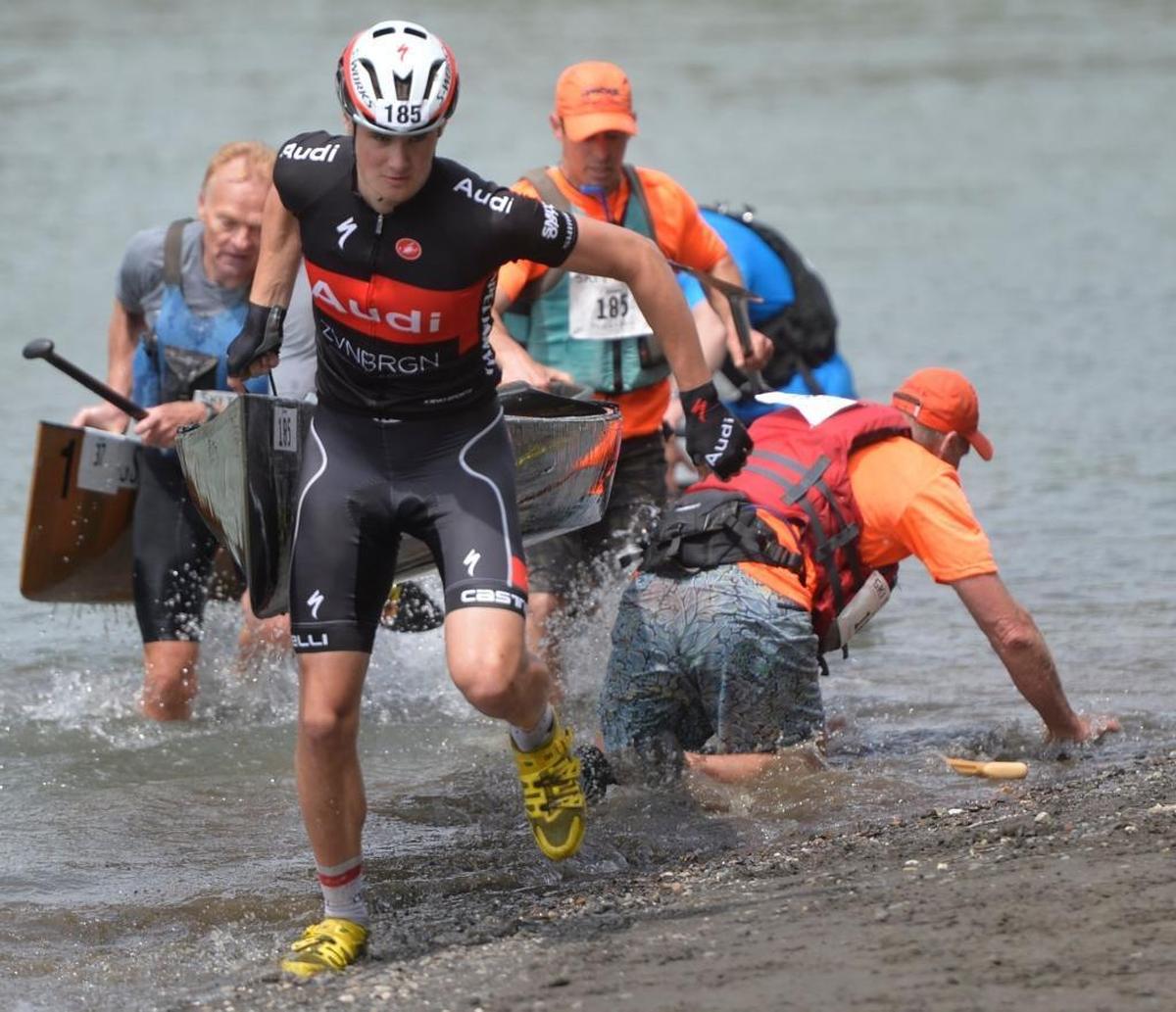 Klicks Running & Walking cross country biker David O'Brien helps his canoe team take their canoe out of the water during annual Ski to Sea Race at Hovander Park in Ferndale, May 24, 2015. Canoeing was canceled in 2008 because of high river flows from heavy snow that winter.
