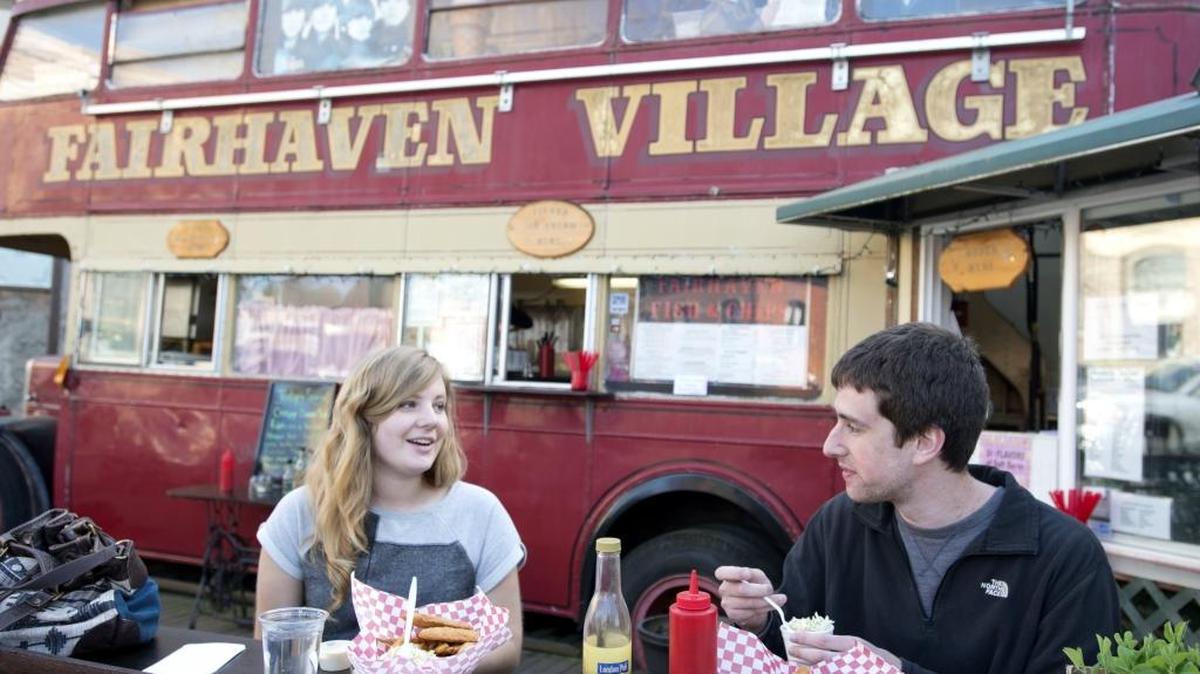 Western Washington University students, Synden Ratzlaff and Sam Witus, enjoy fish and chips and chicken strips in April 2014 at Fairhaven Fish and Chips. Thousands of people will descend on Fairhaven Sunday for the annual Fairhaven Festival and Ski to Sea. They come to hear music, enjoy a beer and wine garden and check out food booths, arts and craft vendors, exhibits and children’s activities.