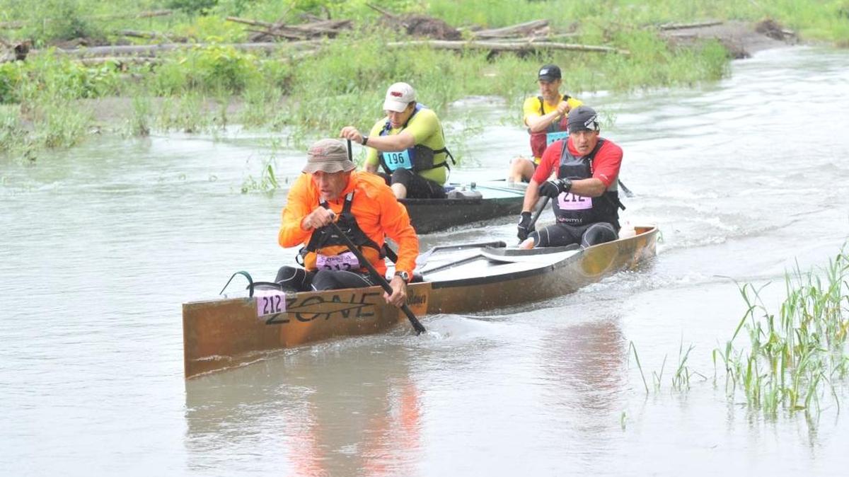 Nick Bauer and Jim Bauer of Bank Of The Pacific Veterans (212) battle Trevor Robinson and Joe Manns of GetSimpleBox.com during the canoeing leg of the 2014 Ski to Sea Race.