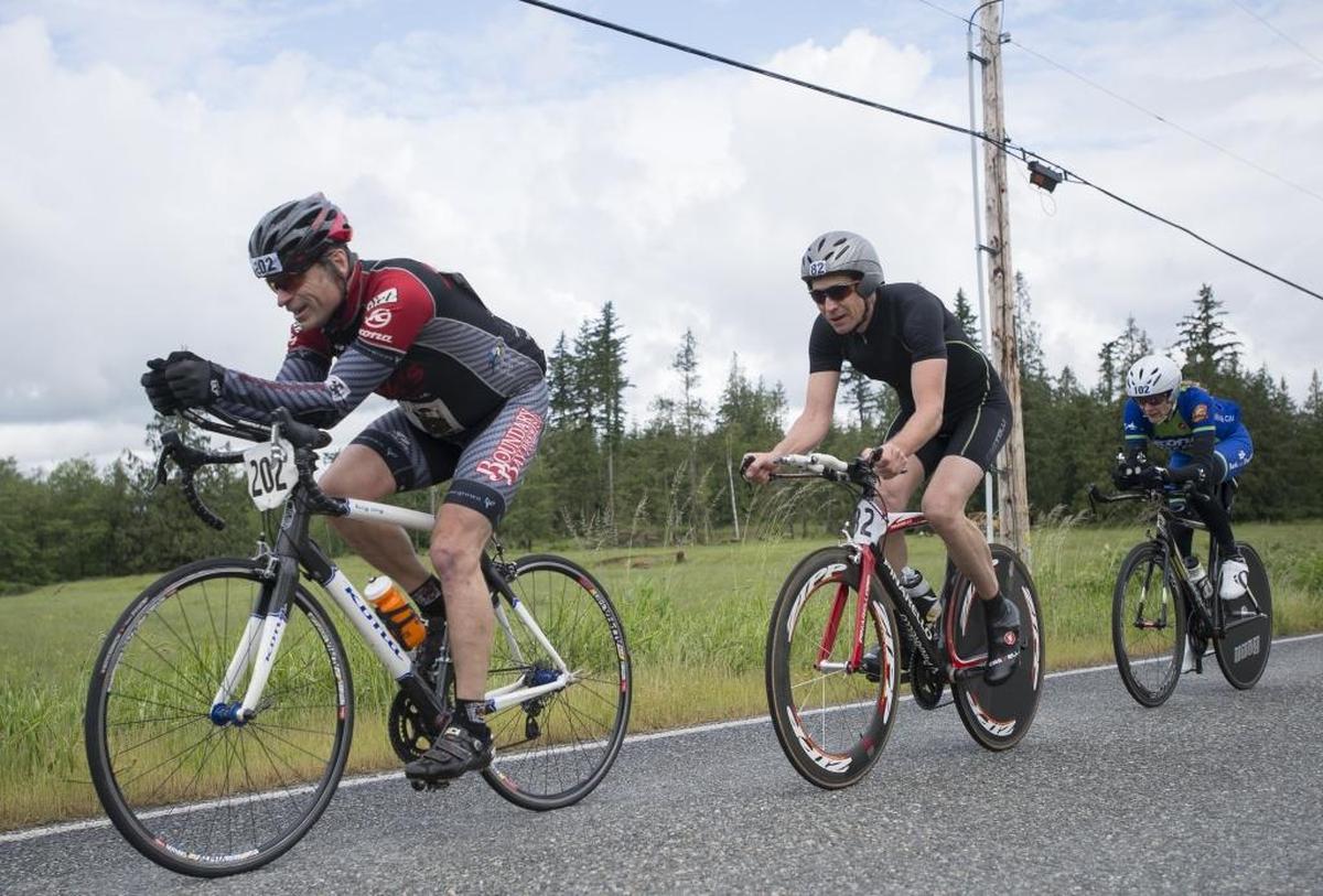 Road bicyclists Jeremy Stafford, left, Nate Reiss and Lise Grace ride down South Pass Road during the road bike leg of the 2016 Ski to Sea near Everson.