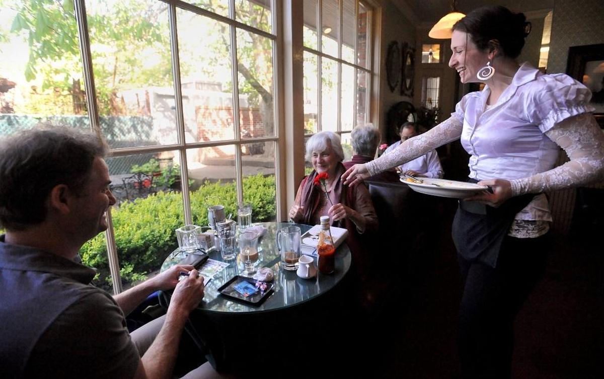 Skylark’s Hidden Cafe waitress Kara Osterman, right, hands Sandy Stork a carnation after having brunch with Pat Perkins, left, for Mother’s Day Sunday morning. Competing in a leg of the Ski to Sea race can work up a hearty appetite.
