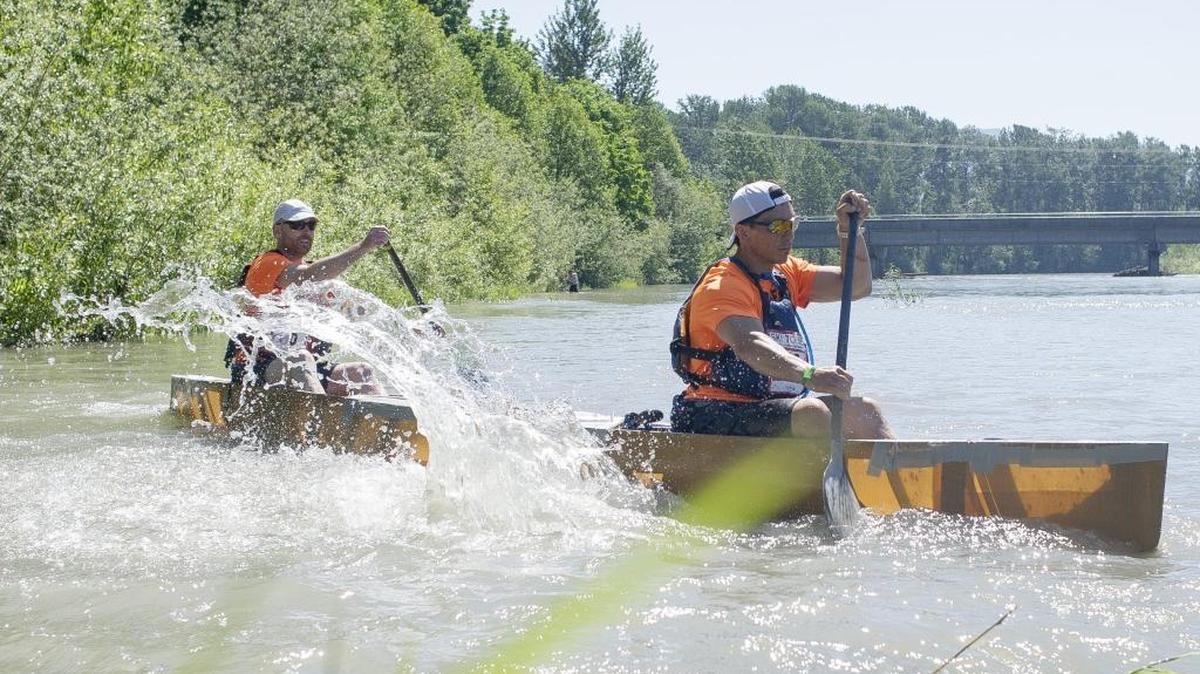 Joshua Hamilton and Aaron Boje of Barlean’s Flax Fanatics set off from the shore at the start of the canoe leg at the 2017 Ski to Sea on the Nooksack River.