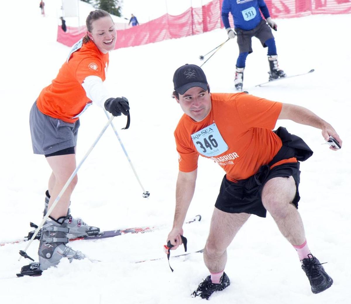 EOD Warriors runner Chris Blount takes the handoff from downhill skier Courtney Razon during the 2014 Ski to Sea at Mt. Baker Ski Area.