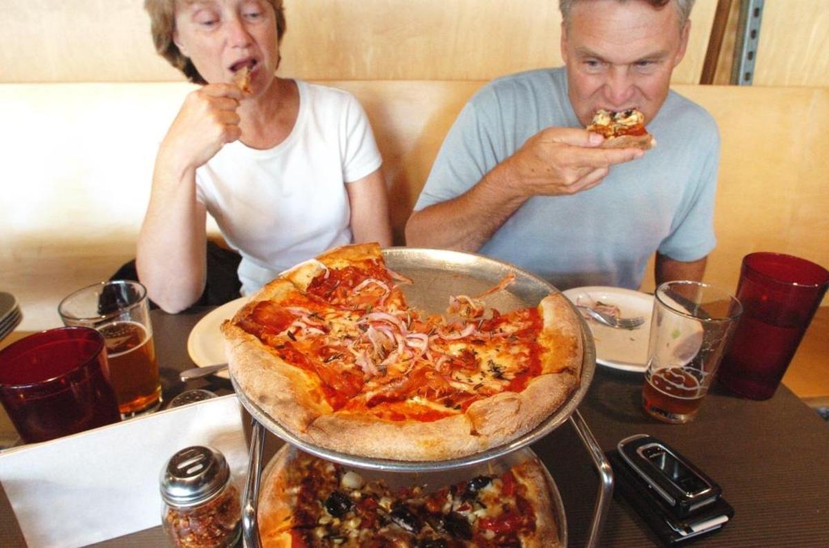 Jean Staehr of Lynden, left, and Tom Staehr of Lynden enjoy pizza at La Fiamma Wood Fire Pizza in Bellingham in August 2007. Competing in a leg of the Ski to Sea race can work up a hearty appetite.