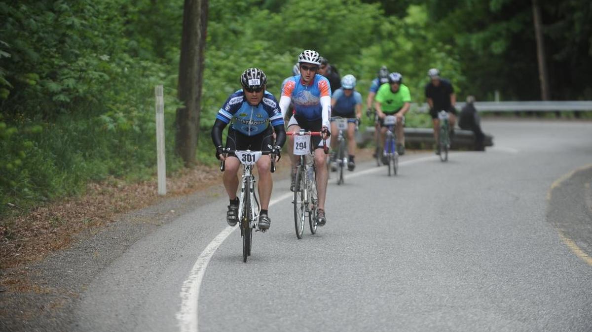 Colin Sankey (301) of Quattro and Brandon Olson (294) of Rollie Pollie Ollie’s lead a pack of cyclists during the road biking leg of the 2012 Ski to Sea Race.