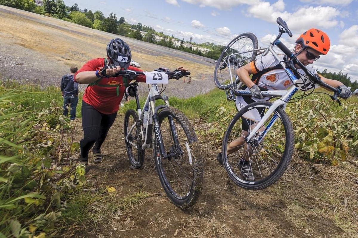 Cyclocross racers Ben Howard, left, and Kason Jammerer negotiate a steep muddy hill at the intersection of Slater and Rural Roads during the 2016 Sea to Ski.