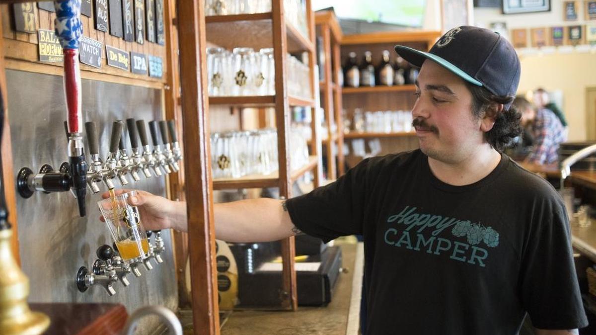 Dillon DuBois pours a beer at Boundary Bay Brewery in May 2017.