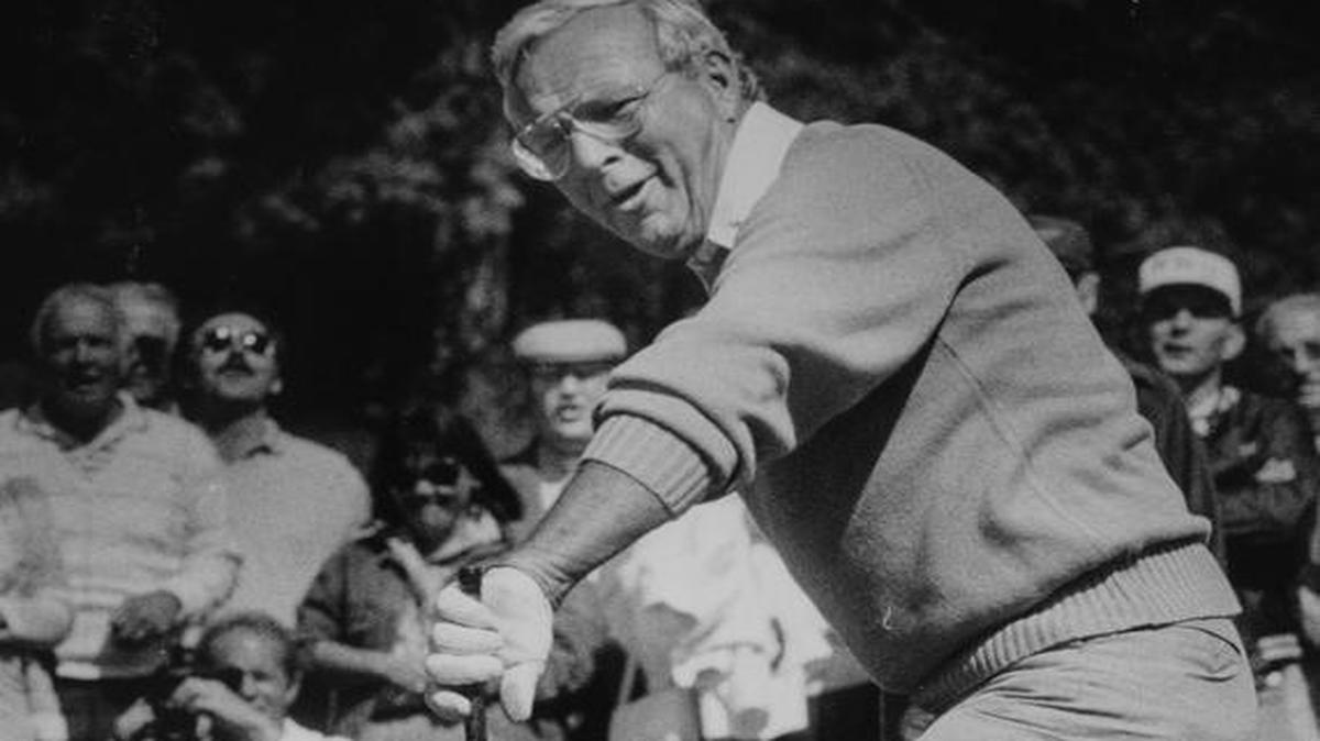 Arnold Palmer tries to coax a putt into the hole on the third green at Semiahmoo Golf & Country Club during a 18-hole exhibition match to dedicate the course on June 22, 1987.