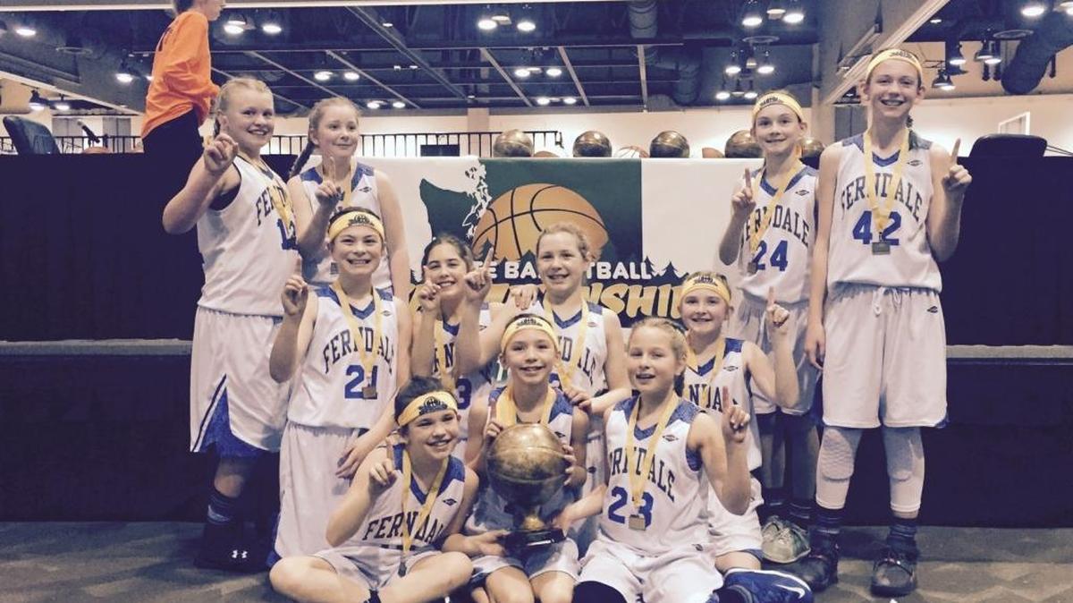 The Ferndale fifth grade AAU girls’ basketball team celebrates winning its division at the Washington Middle School Basketball Association Championships Sunday, March 13, in Spokane.