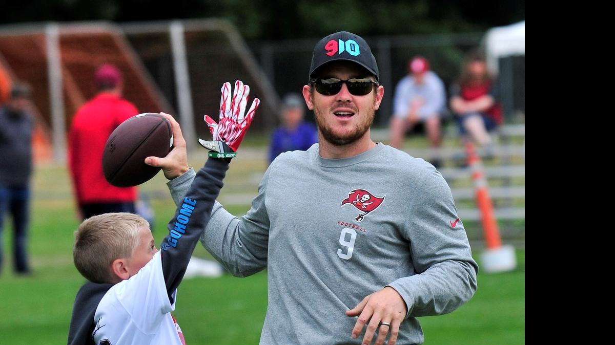 
Tampa Bay Buccaneers punter Michael Koenen passes the ball while scrimmaging with participants of the Michael Koenen/Jake Locker Charity NFL Kids Football Camp on Sunday morning July 20, 2014 at Ferndale High School.
