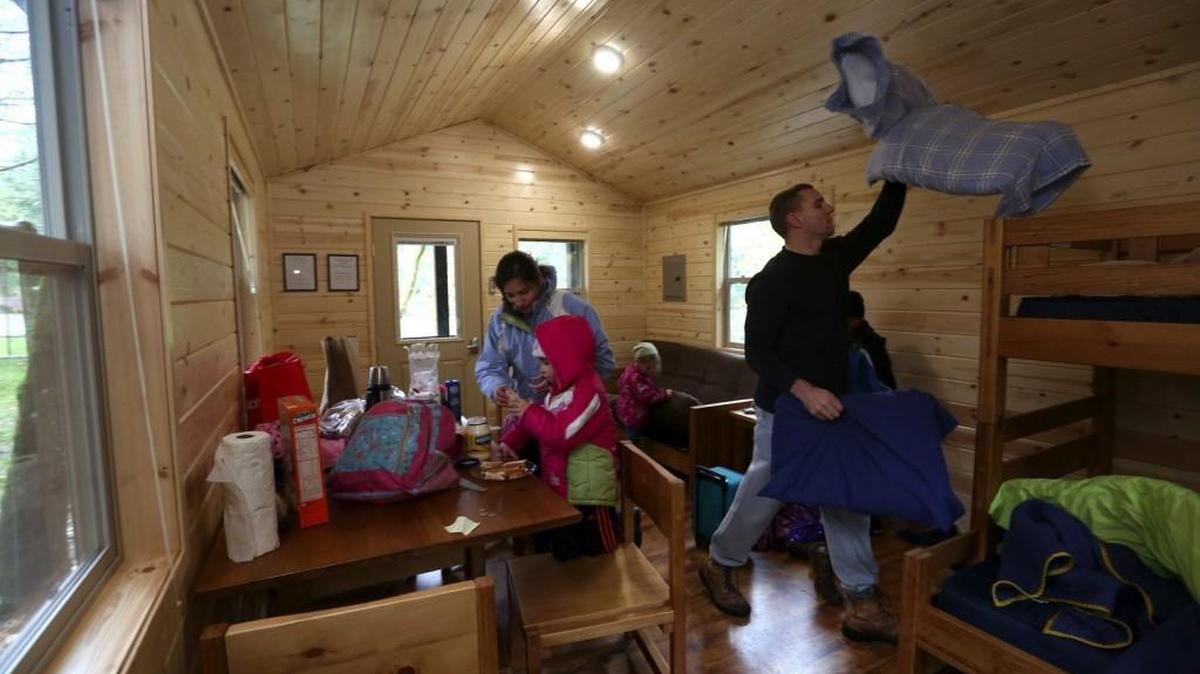 The Thompson family moves into a cabin they rented at Dash Point State Park in Federal Way. The state parks system is trying to attract more campers like the Thompsons, who live in Tacoma, for weekend getaways in park cabins.