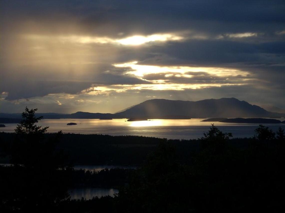 Sunset is seen from the top of Young Hill on the west side of San Juan Island. Young Hill is a one-mile hike in English Camp, part of San Juan National Historic Park.