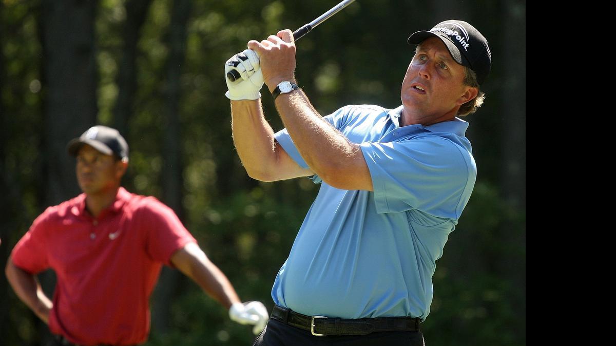 
Phil Mickelson watches his tee shot on the second hole as Tiger Woods looks on at TPC Boston on September 3, 2007 in Norton, Massachusetts.
