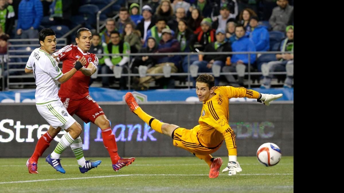 
Seattle Sounders FC goalkeeper Troy Perkins, right, watches as a shot from Club Tijuana's Dayro Moreno, second from left, goes wide to bounce off the post as Moreno fends off the Sounders' Gonzalo Pineda  during the first half of an international friendly soccer match March 24. 
