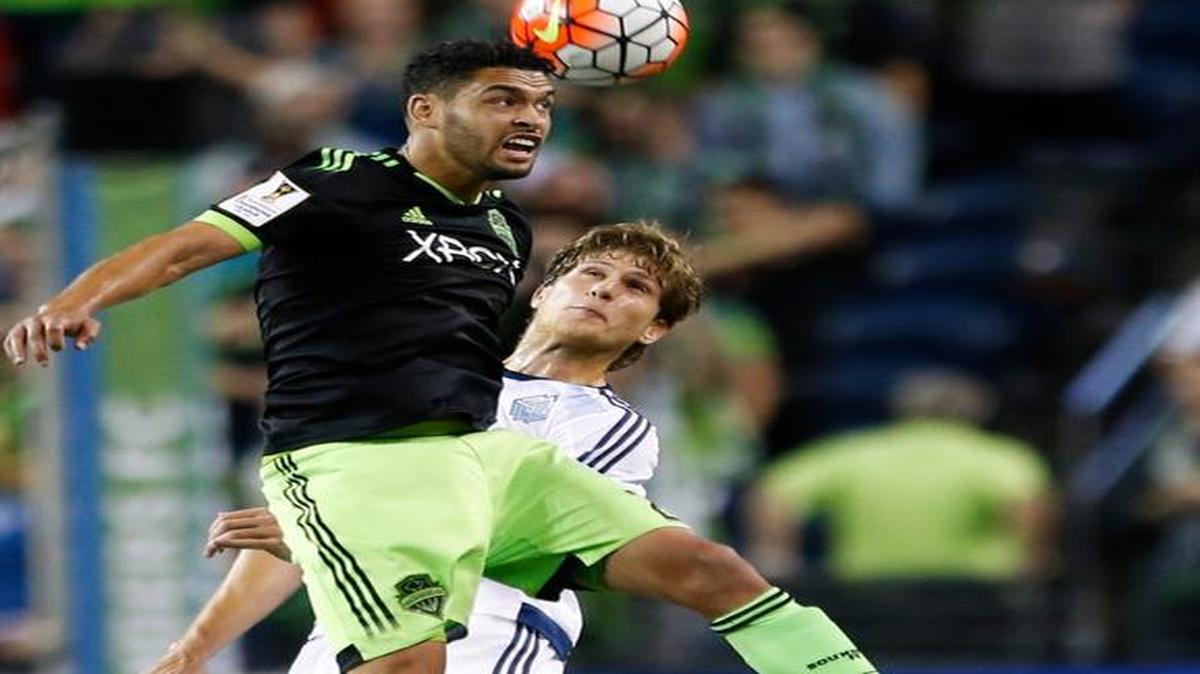 
Sounders midfielder Lamar Neagle wins a header over Vancouver Whitecaps defender Diego Rodriguez during the second half of Wednesday’s CONCACAF Champions League match in Seattle. 
