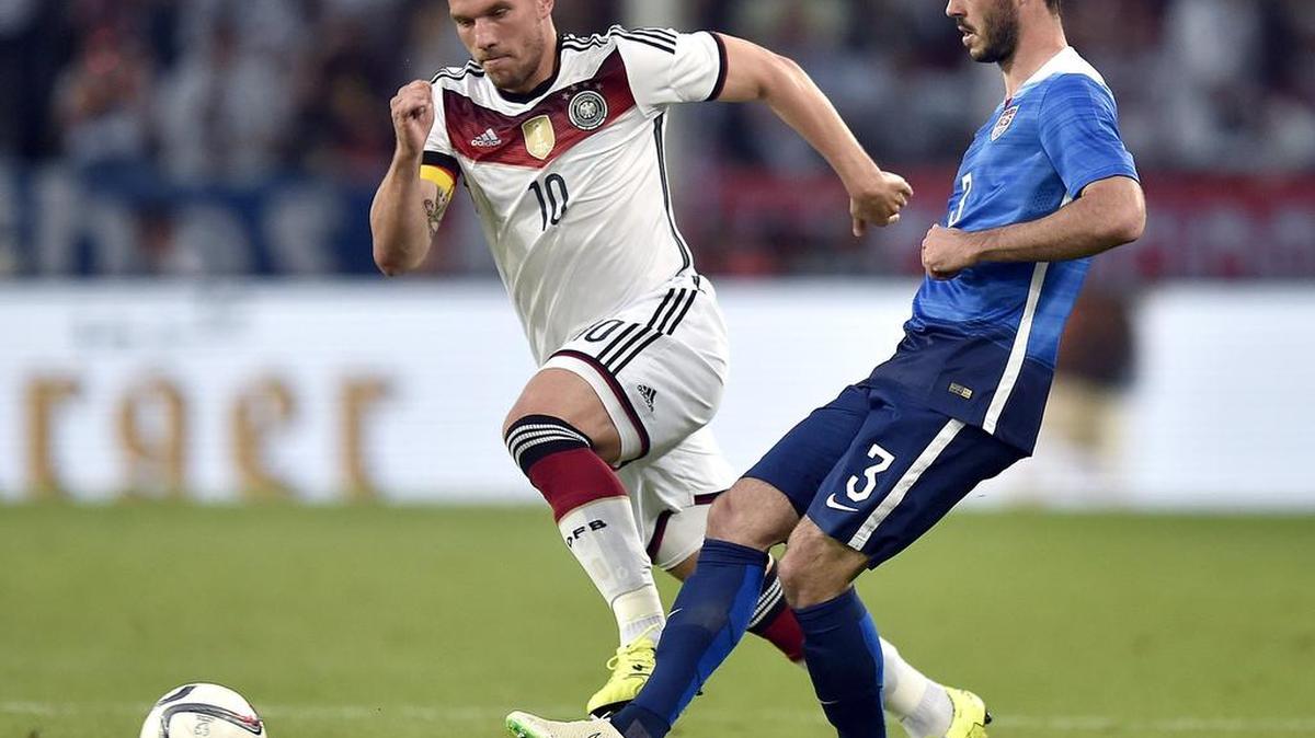 Defender Brad Evans, right, challenges Germany’s Lukas Podolski for the ball during a friendly match between Germany and the United States in June. Evans has 25 career appearances with the national team, including eight in 2015.