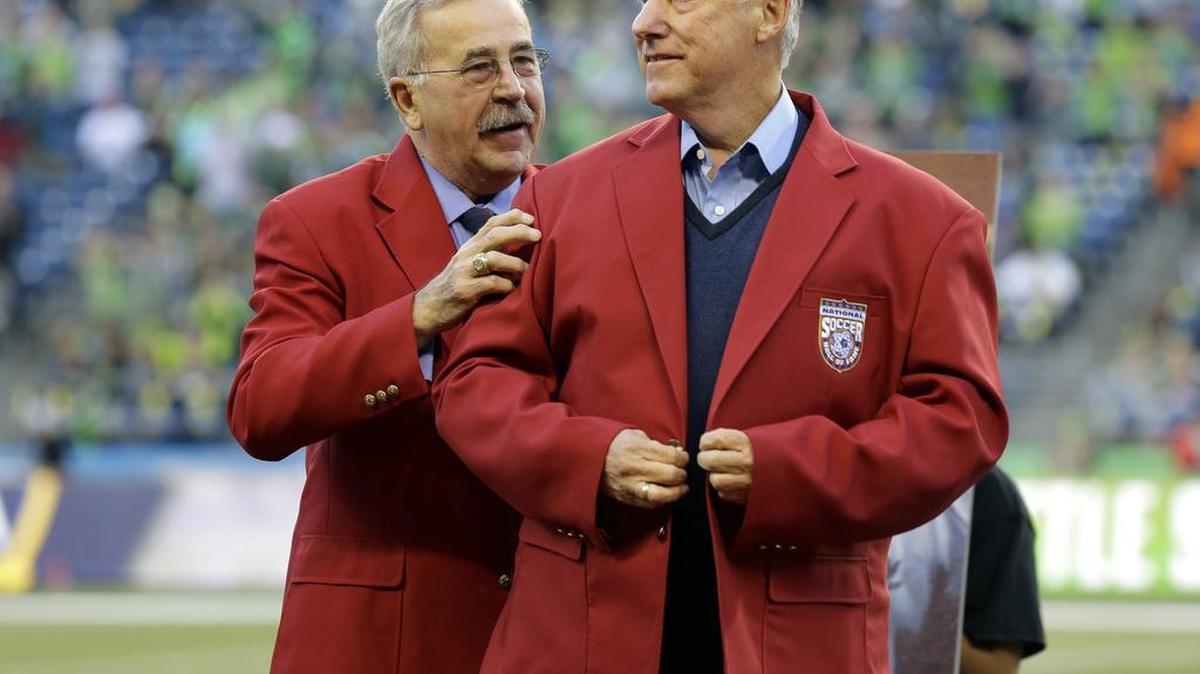 
Seattle Sounders head coach Sigi Schmid, right, is honored with a red jacket presented by Hank Steinbrecher, left, of the U.S. Soccer Hall of Fame, before Sunday match with the LA Galaxy, in Seattle.
