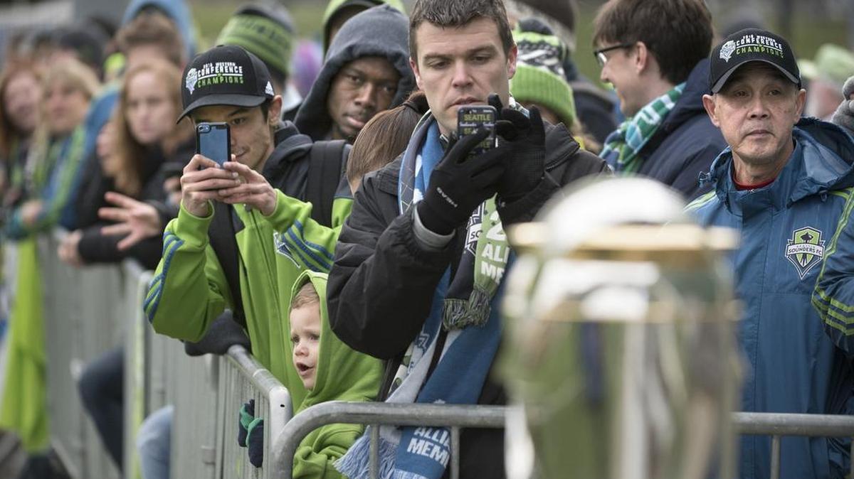Seattle Sounders fans line up to see the players’ workout and the MLS championship trophy at Starfire Sports on Tuesday.