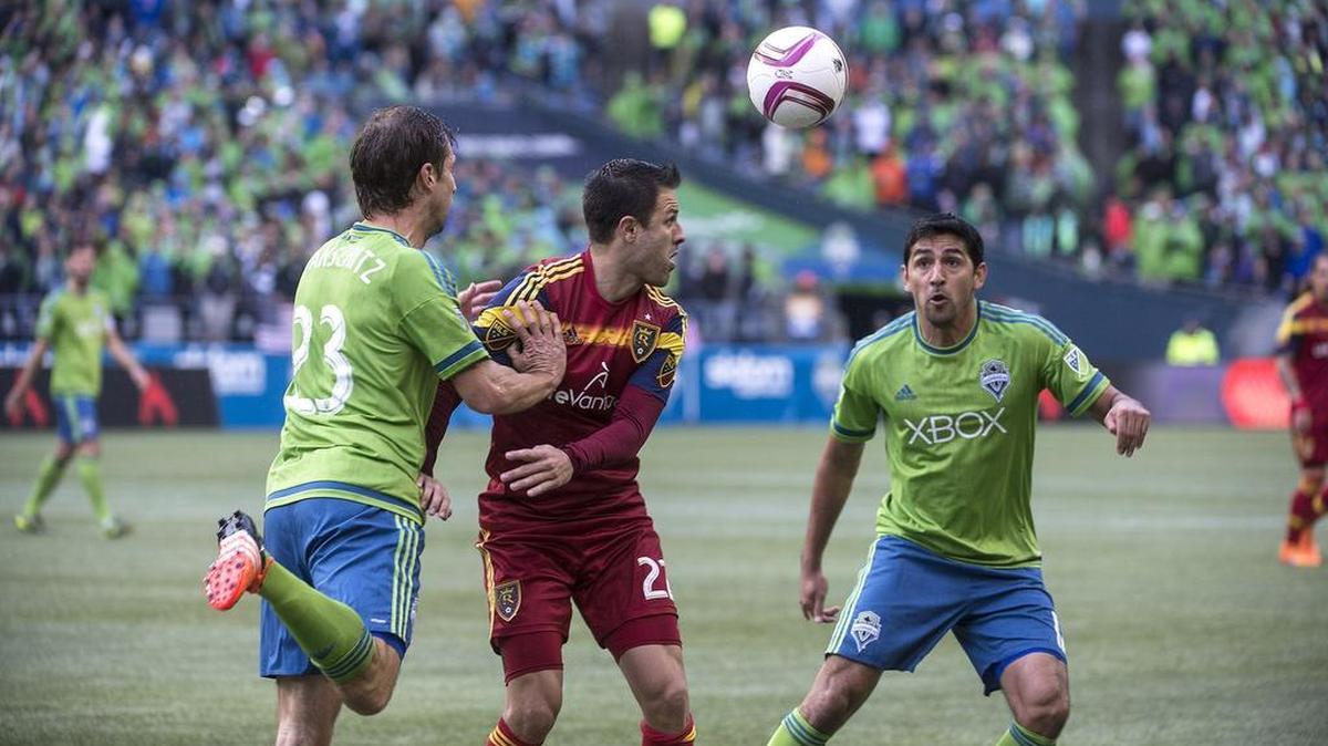 Sounders defenders Andreas Ivanschitz left, and Leo Gonzalez apply pressure against Real Salt Lake on Sunday. Thanks to the Sounders’ 3-1 victory, they will play host to the Los Angeles Galaxy in the playoffs on Wednesday.