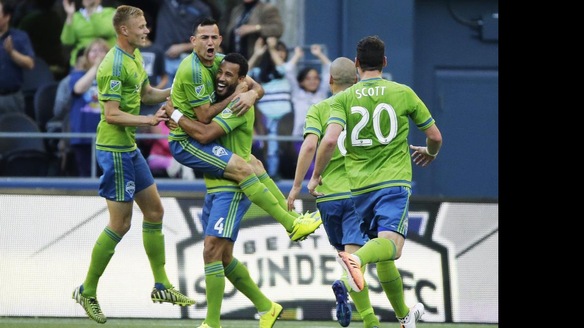 
Seattle Sounders' Marco Pappa, second from left, is mobbed by teammates after Pappa scored a goal against the Colorado Rapids in the first half of an MLS soccer match, Wednesday, May 27, 2015, in Seattle. The Sounders beat the Rapids 1-0.

