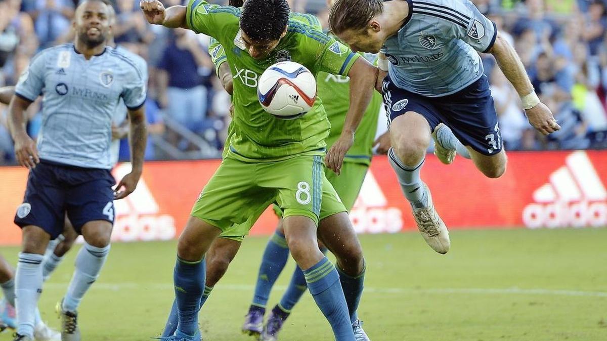 
Seattle’s Gonzalo Pineda and Sporting Kansas City’s Jacob Peterson try to head a corner kick Sunday at Sporting Park in Kansas City. The Sounders played to a 1-1 draw.
