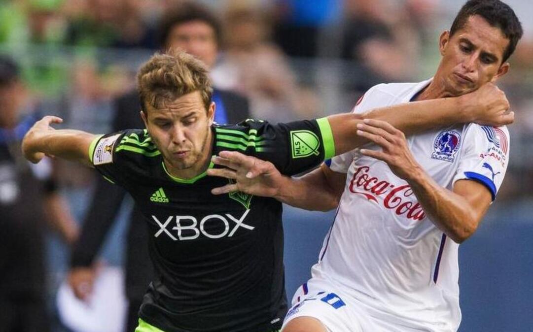 
Seattle’s Thomás, left, drives against C.D. Olimpia's Oliver Morazan during the first half of the Sounders’ 2-1 win in a CONCACAF Champions League soccer match on Aug. 19 in Seattle. The two teams will play against on Wednesday in the Honduras. 
