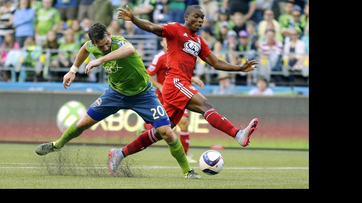 
Seattle Sounders’ Zach Scott, left, competes for the ball with FC Dallas’ Fabian Castillo during the first half of an MLS soccer match Saturday in Seattle. 
