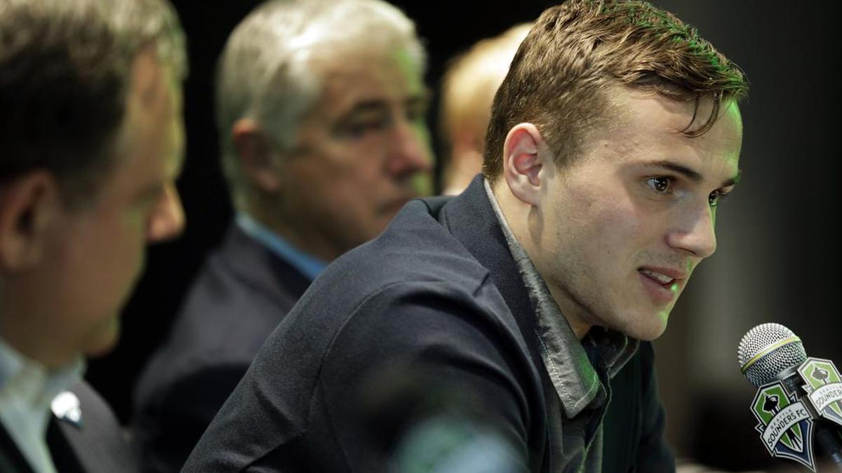 Jordan Morris, right, speaks Thursday, Jan. 21, 2016, in Seattle after the MLS soccer Seattle Sounders FC announced his signing as a forward. Morris, who played for Stanford, was the Hermann Trophy winner in 2015 as the top college player in the country.