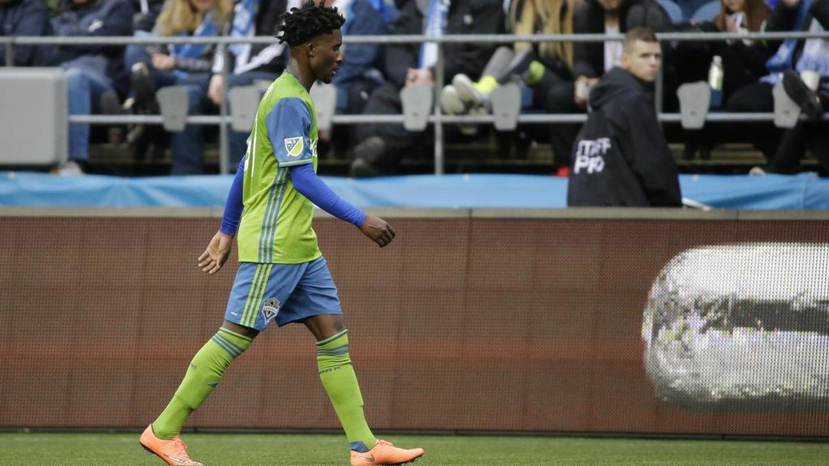 Seattle’s Oniel Fisher walks off the field after getting a red card in the Sounders’ 1-0 loss to Sporting Kansas City.