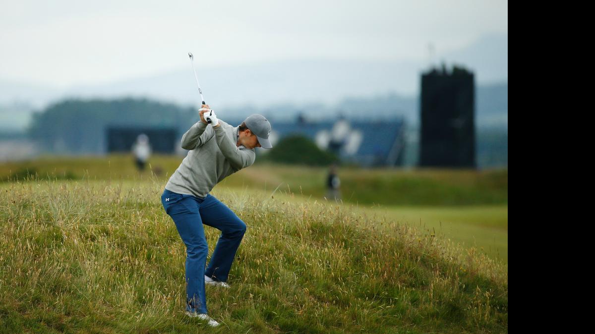 
Jordan Spieth plays out of the rough on the fourth hole during a practice round Tuesday for the British Open at the Old Course, St. Andrews, Scotland. Spieth is favored by oddsmakers to win the third event in the Grand Slam of golf.
